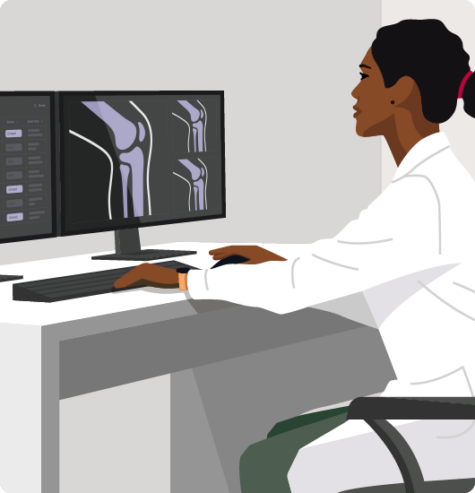 A healthcare professional analyzing radiographic images on a computer screen in a medical office setting.