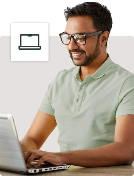 A smiling man with glasses working contentedly on his laptop at a desk, with an icon symbolizing file storage in the background.
